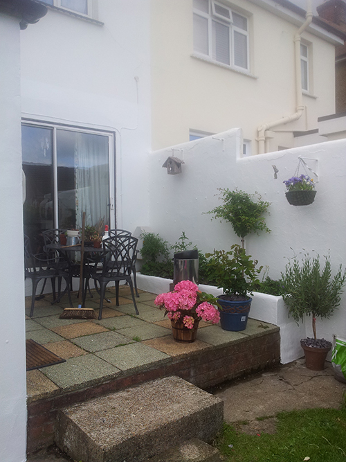  WE PAINTED EVERYTHING WHITE AND TURNED THIS LADIES PATIO INTO A TROPICAL PARADISE