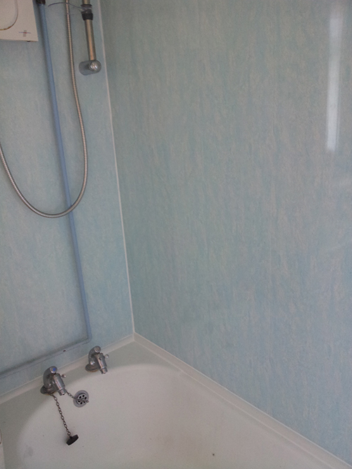 WE COVERED THE TILES WITH UPVC BATHROOM CLADDING. 